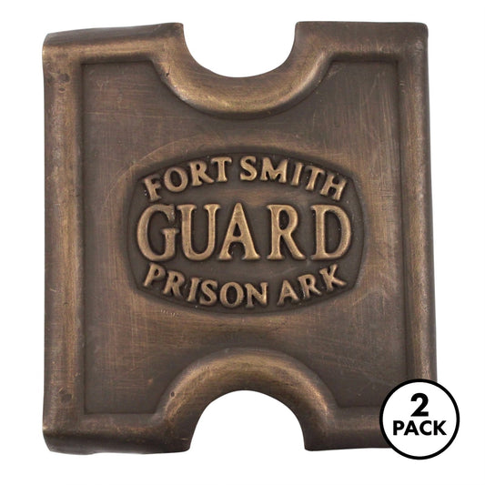 Two brass belt buckles labeled Fort Smith Prison Guard