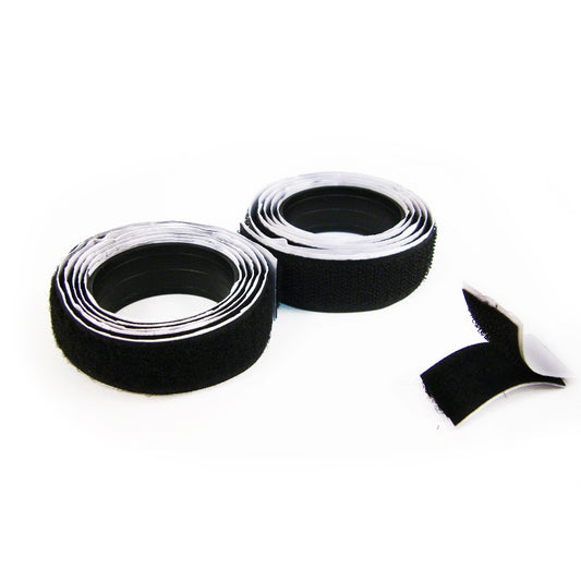 Roll of black hook and loop self-adhesive sewing tape, showing the tape's width.