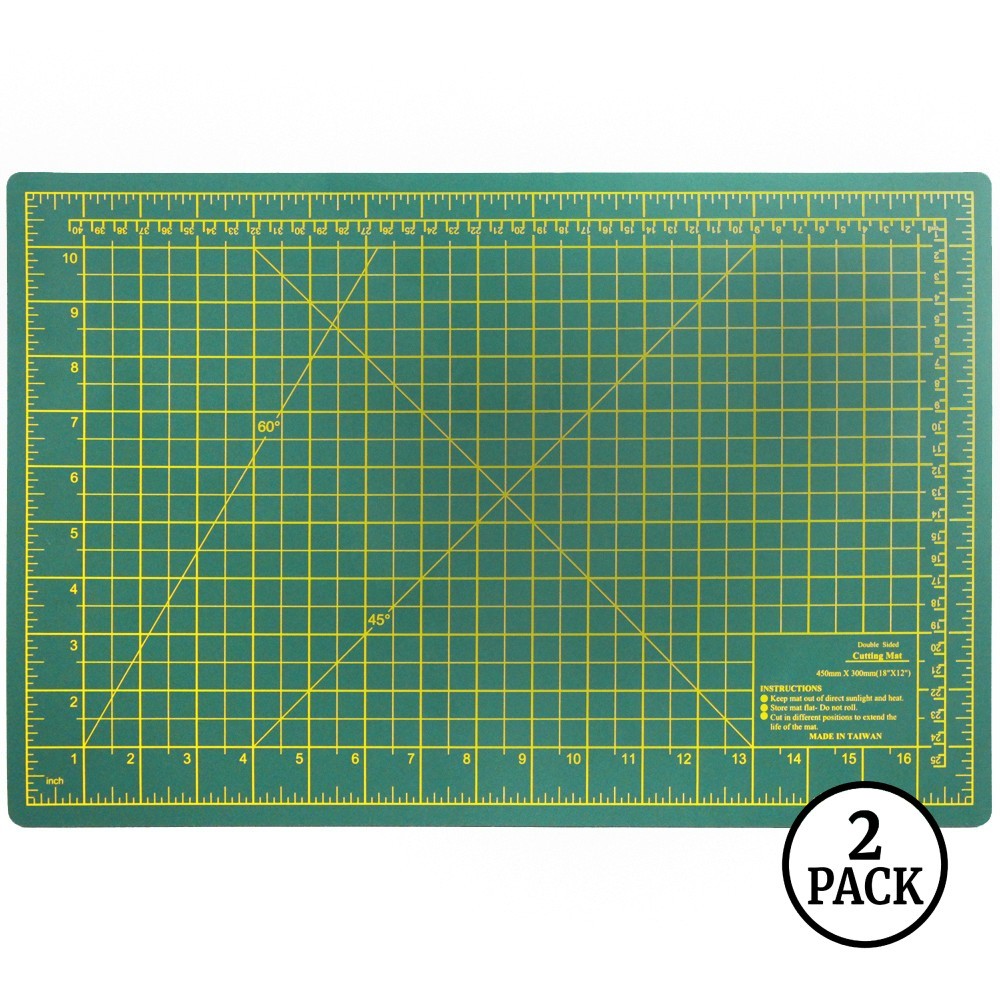 Two large green double-sided self-healing cutting mats, each 18 by 12 inches, shown side by side.