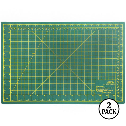 Two large green double-sided self-healing cutting mats, each 18 by 12 inches, shown side by side.