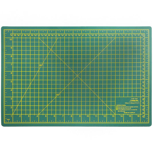 Green double-sided self-healing cutting mat, 18 by 12 inches, with grid lines
