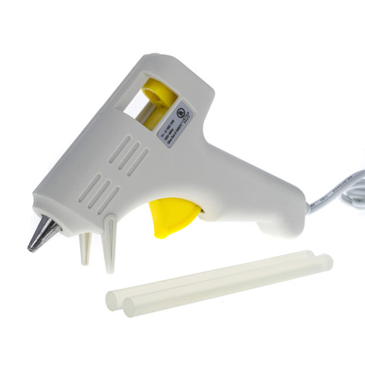 mini glue gun and two hot glue sticks kit on plain surface