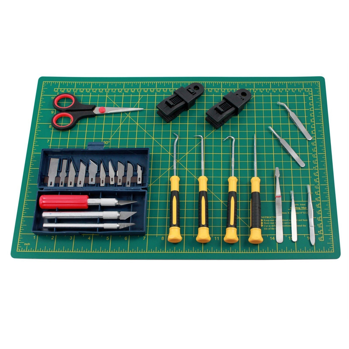 Vinyl cutting kit with self-healing mat and clamps laid out for craft use.