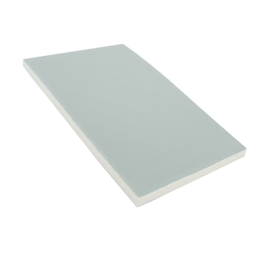 Small stack of dissolving message memo pad sheets with light markings on a flat surface